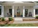 Inviting front porch featuring rocking chairs and swing at 250 Hembree Rd, Roswell, GA 30075