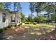 Well-maintained front yard with lush green grass, mature trees, and charming porch swing at 250 Hembree Rd, Roswell, GA 30075