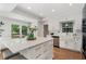 Bright kitchen featuring quartz countertops, a large island, and stainless steel appliances at 250 Hembree Rd, Roswell, GA 30075