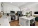 Modern kitchen with white cabinets, stainless steel appliances, and island with seating at 250 Hembree Rd, Roswell, GA 30075