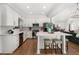 Modern kitchen with white cabinets, stainless steel appliances, and island with seating at 250 Hembree Rd, Roswell, GA 30075