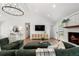 Spacious living room showcasing a cozy fireplace and contemporary lighting fixture at 250 Hembree Rd, Roswell, GA 30075