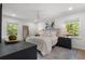 Sun-filled main bedroom with large windows, ceiling fan, and neutral decor at 250 Hembree Rd, Roswell, GA 30075