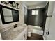Updated bathroom featuring granite counters and a shower-tub combo at 3706 Larkspur Ter, Decatur, GA 30032