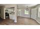 Open floor plan kitchen with white cabinets, granite countertops, and stainless steel appliances at 3706 Larkspur Ter, Decatur, GA 30032