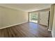 Open living room featuring a large window with natural light and wood-look floors at 3706 Larkspur Ter, Decatur, GA 30032