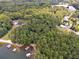 A serene aerial view of a wooded property with lake access and private docks at 5122 Cantrell Se Pt, Acworth, GA 30101