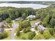 Stunning aerial view of stately homes nestled among lush trees near a serene lake at 5122 Cantrell Se Pt, Acworth, GA 30101