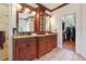This bathroom features and sinks with dark wood cabinets and a spacious closet at 5122 Cantrell Se Pt, Acworth, GA 30101