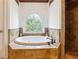 This bathroom features a garden tub, stained glass window, and a walk-in shower at 5122 Cantrell Se Pt, Acworth, GA 30101