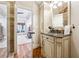 Charming bathroom with marble countertop vanity and an open doorway to the main bedroom at 5122 Cantrell Se Pt, Acworth, GA 30101