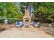 Inviting outdoor fireplace with comfortable seating, perfect for entertaining in a serene setting at 5122 Cantrell Se Pt, Acworth, GA 30101