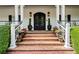 Elegant front entrance with a beautifully adorned doorway, brick steps, and manicured landscaping at 5122 Cantrell Se Pt, Acworth, GA 30101