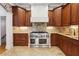 Gourmet kitchen featuring custom wood cabinets, high-end appliances, and tiled backsplash at 5122 Cantrell Se Pt, Acworth, GA 30101