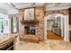 Open kitchen featuring a brick fireplace, tiled floors, and access to the dining room at 5122 Cantrell Se Pt, Acworth, GA 30101