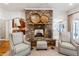 Inviting living room showcasing a stone fireplace, seating, and views into adjacent rooms at 5122 Cantrell Se Pt, Acworth, GA 30101