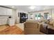 Inviting living room features a large TV, white cabinets, and access to the outdoors at 5122 Cantrell Se Pt, Acworth, GA 30101