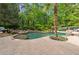 A beautiful backyard pool area with a natural stone waterfall feature and mature landscaping creates a serene oasis at 5122 Cantrell Se Pt, Acworth, GA 30101
