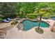 Stunning backyard with a freeform pool, lush landscaping, and a relaxing hot tub at 5122 Cantrell Se Pt, Acworth, GA 30101
