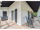 Inviting porch with rocking chairs, black shutters, and warm lighting, creating a relaxing outdoor space at 5122 Cantrell Se Pt, Acworth, GA 30101