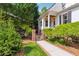 Charming side entrance featuring a brick path, iron gate, and lush landscaping, offering a private entry at 5122 Cantrell Se Pt, Acworth, GA 30101