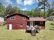 View of the home's backyard featuring a deck and wooded area at 7371 Ovis Ct, Riverdale, GA 30274