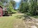 Spacious, green backyard with access to a deck and additional doors into the home at 7371 Ovis Ct, Riverdale, GA 30274