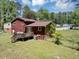 The back of this home has a nice backyard with a wooden deck and a grassy lawn at 7371 Ovis Ct, Riverdale, GA 30274
