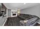 Spacious finished basement with a large sectional couch, fireplace, and mounted TV at 7371 Ovis Ct, Riverdale, GA 30274