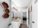 This bathroom features a granite countertop and wood-look flooring at 7371 Ovis Ct, Riverdale, GA 30274