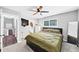 Bedroom features a ceiling fan, a window and a full bath at 7371 Ovis Ct, Riverdale, GA 30274