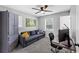 Cozy bedroom with a sofa bed, a desk, and a ceiling fan at 7371 Ovis Ct, Riverdale, GA 30274