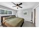 Carpeted bedroom featuring a ceiling fan, two windows and natural light at 7371 Ovis Ct, Riverdale, GA 30274