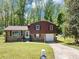 Charming two-story home with brick and brown siding, featuring a well-manicured lawn at 7371 Ovis Ct, Riverdale, GA 30274