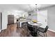 Well-lit kitchen with white cabinets, granite countertops, eat-in dining, and modern stainless steel appliances at 7371 Ovis Ct, Riverdale, GA 30274