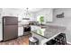 Well-lit kitchen with white cabinets, granite countertops, eat-in dining, and modern stainless steel appliances at 7371 Ovis Ct, Riverdale, GA 30274