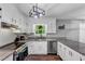 Well-lit kitchen features granite countertops, stainless steel appliances, and hardwood floors at 7371 Ovis Ct, Riverdale, GA 30274