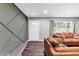 Inviting living room with wood-look floors, recessed lighting, and comfortable, modern furnishings at 7371 Ovis Ct, Riverdale, GA 30274