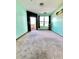 Carpeted bedroom with black accent wall, natural light, and a balcony at 898 Oak Sw St # 1418, Atlanta, GA 30310