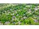An aerial view of luxury homes nestled among mature trees in a quiet suburban neighborhood with golf course in background at 1412 Lanier Ne Mnr, Atlanta, GA 30319