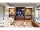 Entertainment area in a finished basement with custom media cabinet and comfortable seating with throw pillows at 1412 Lanier Ne Mnr, Atlanta, GA 30319