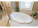 Bathroom featuring a soaking tub, neutral countertops, large window and luxury tile flooring at 1412 Lanier Ne Mnr, Atlanta, GA 30319