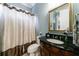 Stylish bathroom featuring a vanity with a dark countertop and elegant fixtures and a shower with a curtain at 1412 Lanier Ne Mnr, Atlanta, GA 30319
