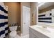 Bright bathroom featuring a white vanity, blue striped shower curtain, and tiled floors at 1412 Lanier Ne Mnr, Atlanta, GA 30319