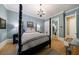 Relaxing bedroom boasts a four-poster bed, chandelier, and access to the ensuite bathroom at 1412 Lanier Ne Mnr, Atlanta, GA 30319