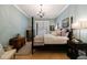 Calm bedroom features a four-poster bed, chandelier, and soft blue walls at 1412 Lanier Ne Mnr, Atlanta, GA 30319