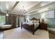 Relaxing bedroom with a chandelier, natural light, and wood floors, creating a tranquil retreat at 1412 Lanier Ne Mnr, Atlanta, GA 30319