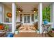 Charming covered porch with a ceiling fan, comfortable seating, and views of a lush backyard at 1412 Lanier Ne Mnr, Atlanta, GA 30319