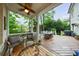 Inviting covered porch with comfortable seating and dining area overlooking a lush backyard at 1412 Lanier Ne Mnr, Atlanta, GA 30319