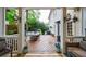 Covered porch overlooking an outdoor dining set, grill, and landscaped backyard with mature trees at 1412 Lanier Ne Mnr, Atlanta, GA 30319